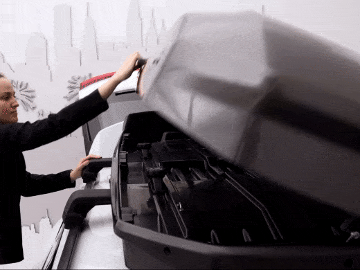 Thule SlideLock on the Motion 3 rooftop cargo box makes for easy one-handed opening, closing and securely locking.