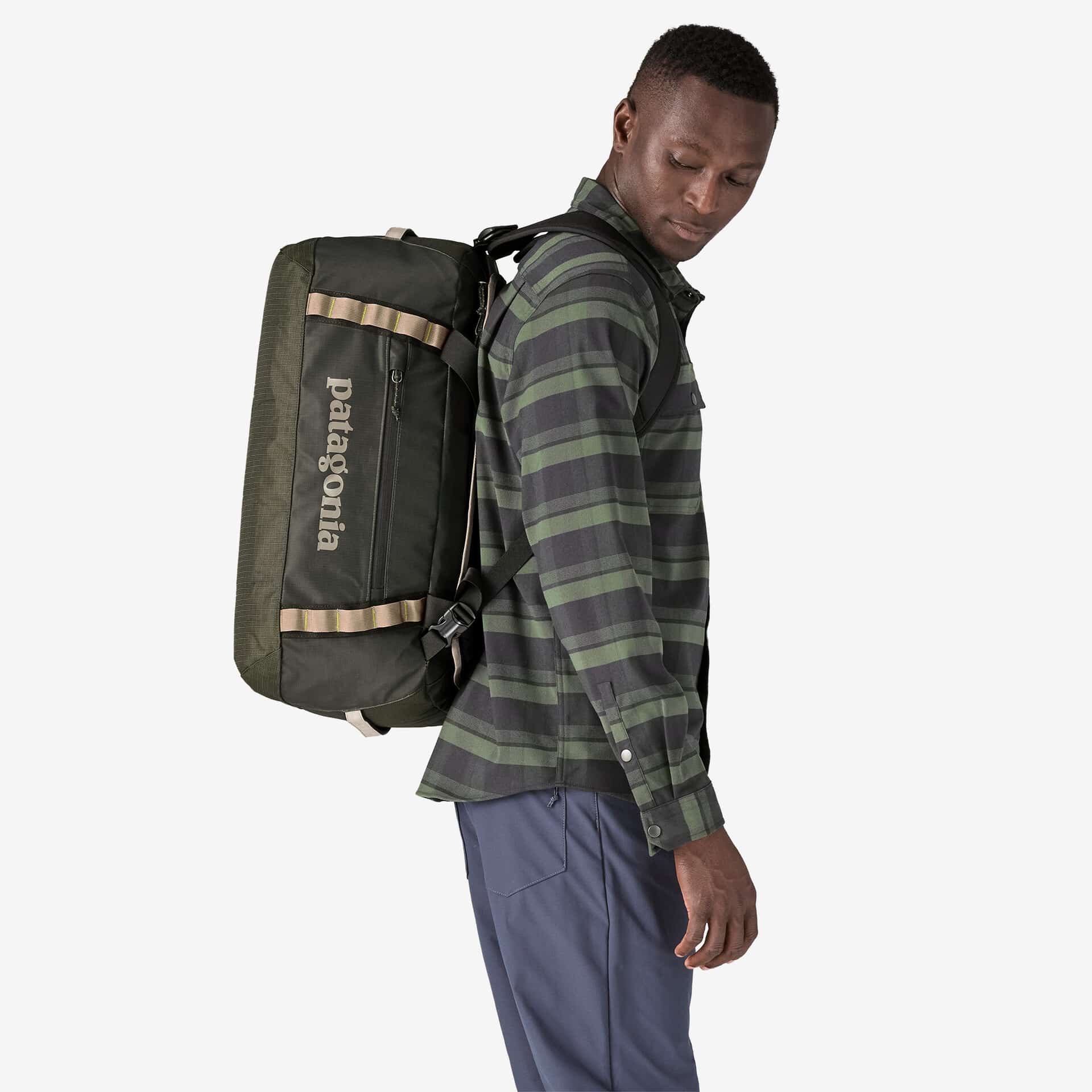 A man wearing a Patagonia Black Hole Duffle on his back.