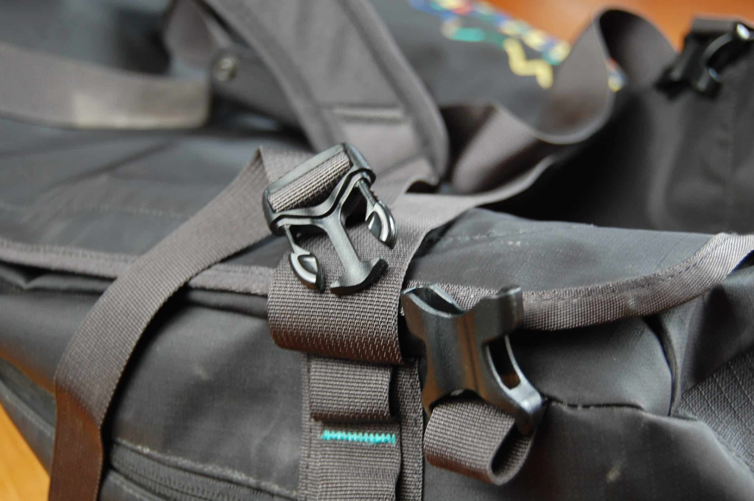 AN image showing the side-release buckles on the backpack straps of a Patagonia Black Hole duffel.