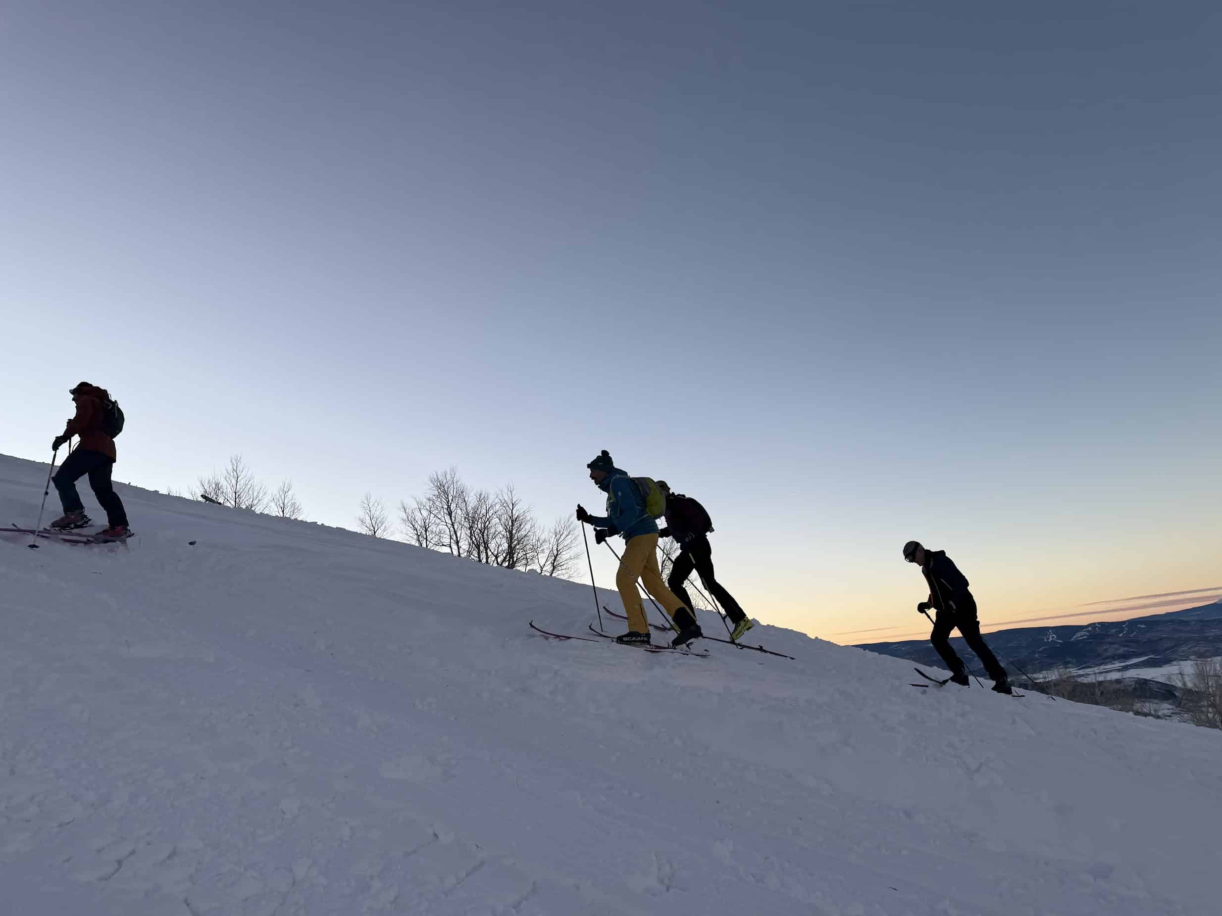 Skiers ski-touring up hill