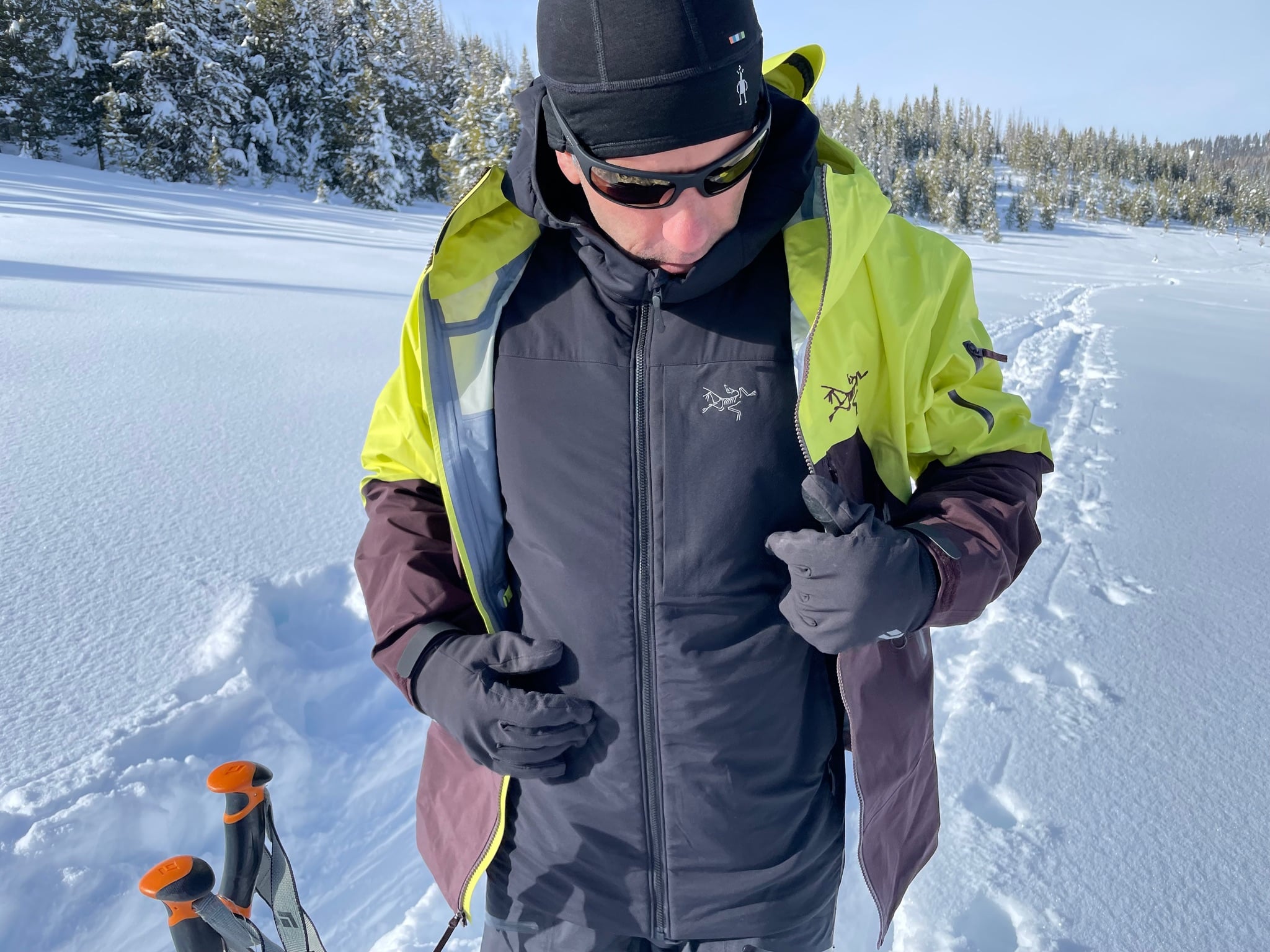 A man ski touring wearing the Arc'teryx Allium jacket as a midlayer under the Arc'teryx Rush jacket.