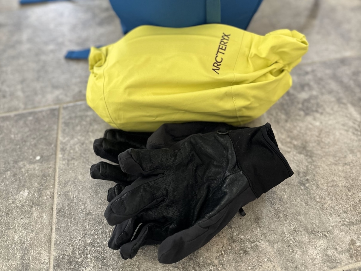 Image of the Arc'teryx Rush ski jacket rolled up in its hood.