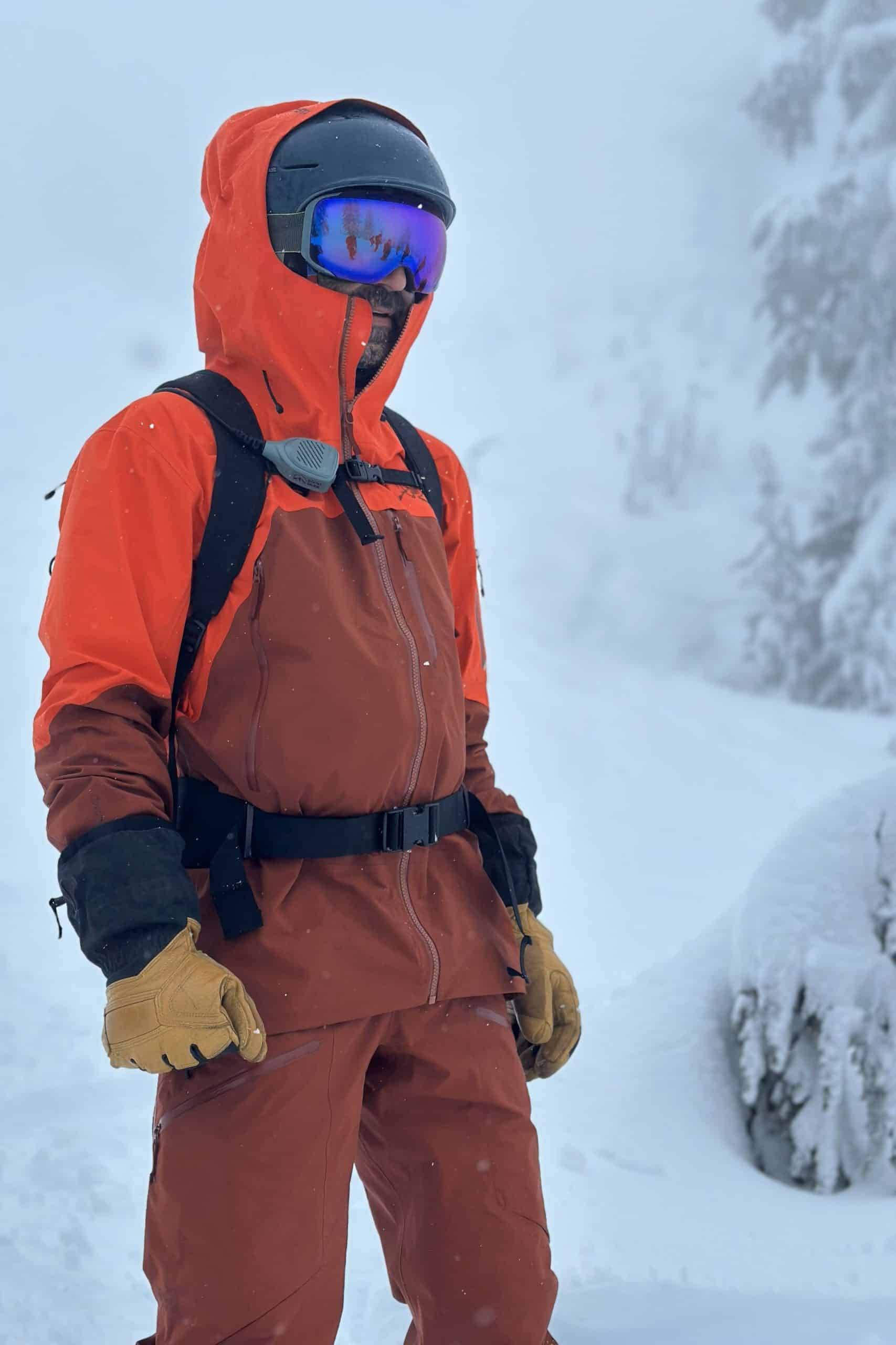 Snowboarder standing in the Arc'teryx Rush ski jacket and bib pant.