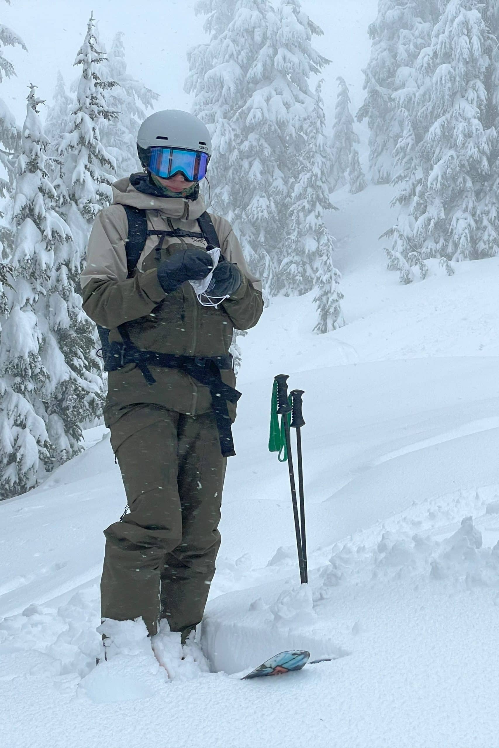Skier standing in the women's Arc'teryx Rush ski jacket and bib pant.