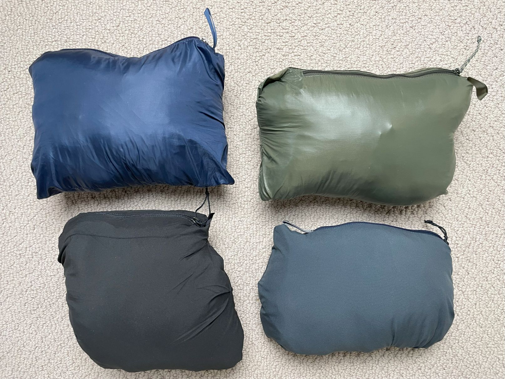 The Patagonia Nano Puff, Micro Puff, Nano Air, and Nano Air Ultralight all stuffed into their pockets.