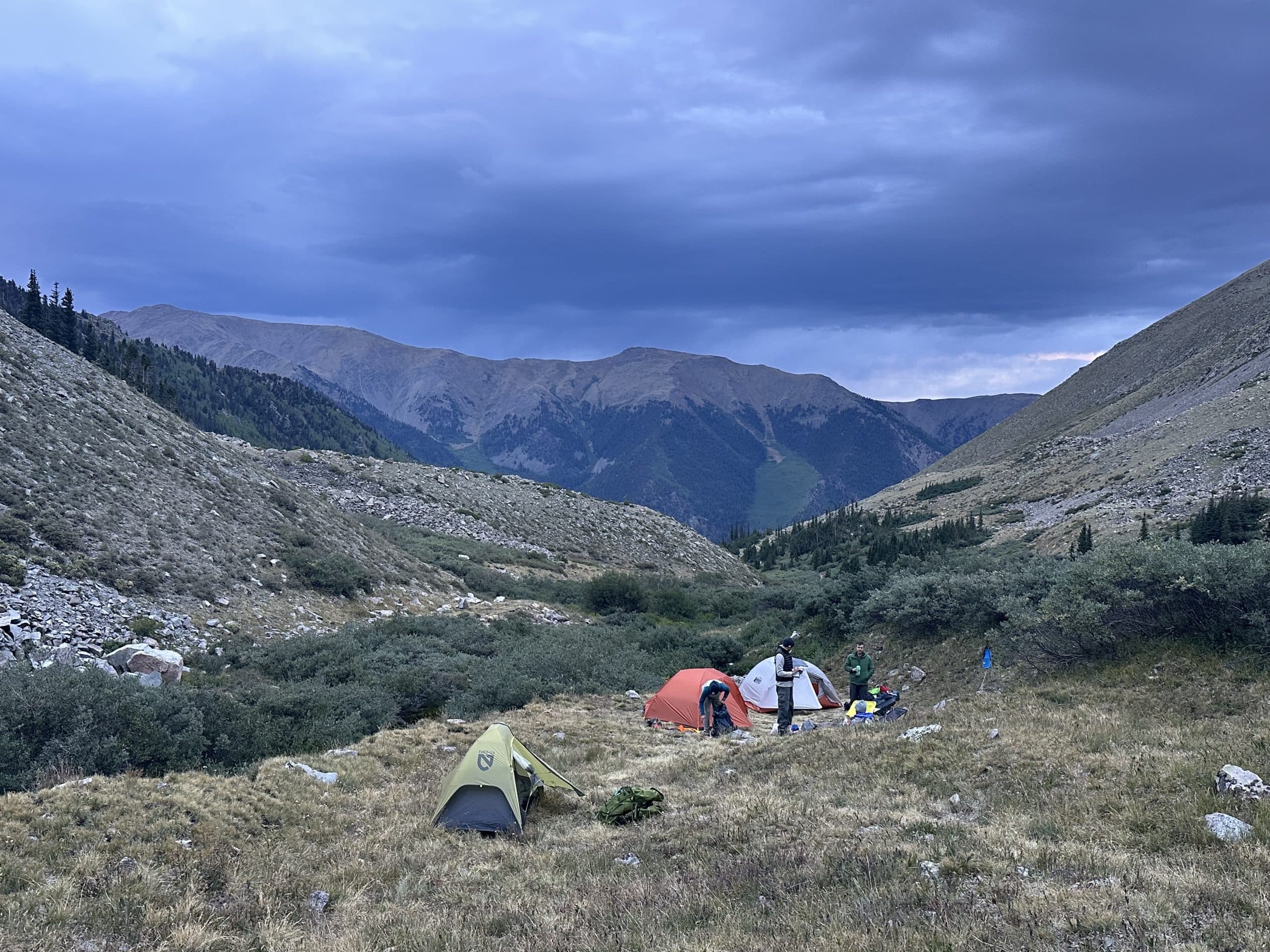 best_backpacking_tents_hero Ultralight backpacking tents pitched in the mountains with a stormy sky.