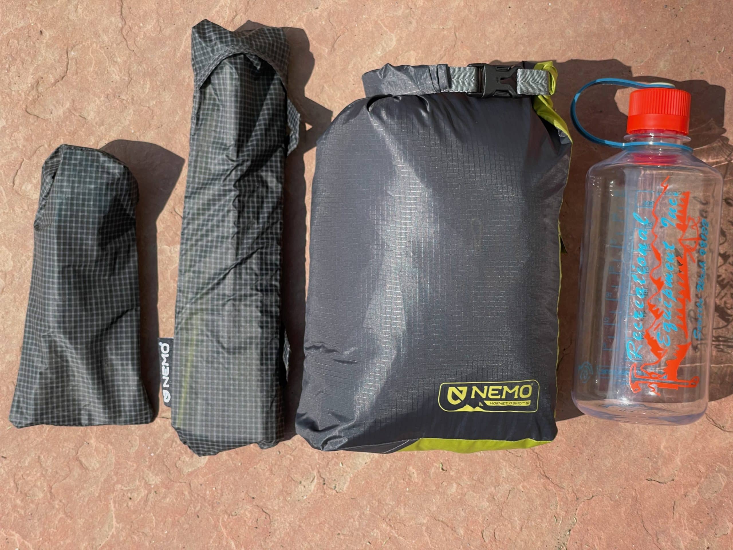 The parts of the Nemo Hornet OSMO 1 ultralight backpacking tent in their stuff sacks.