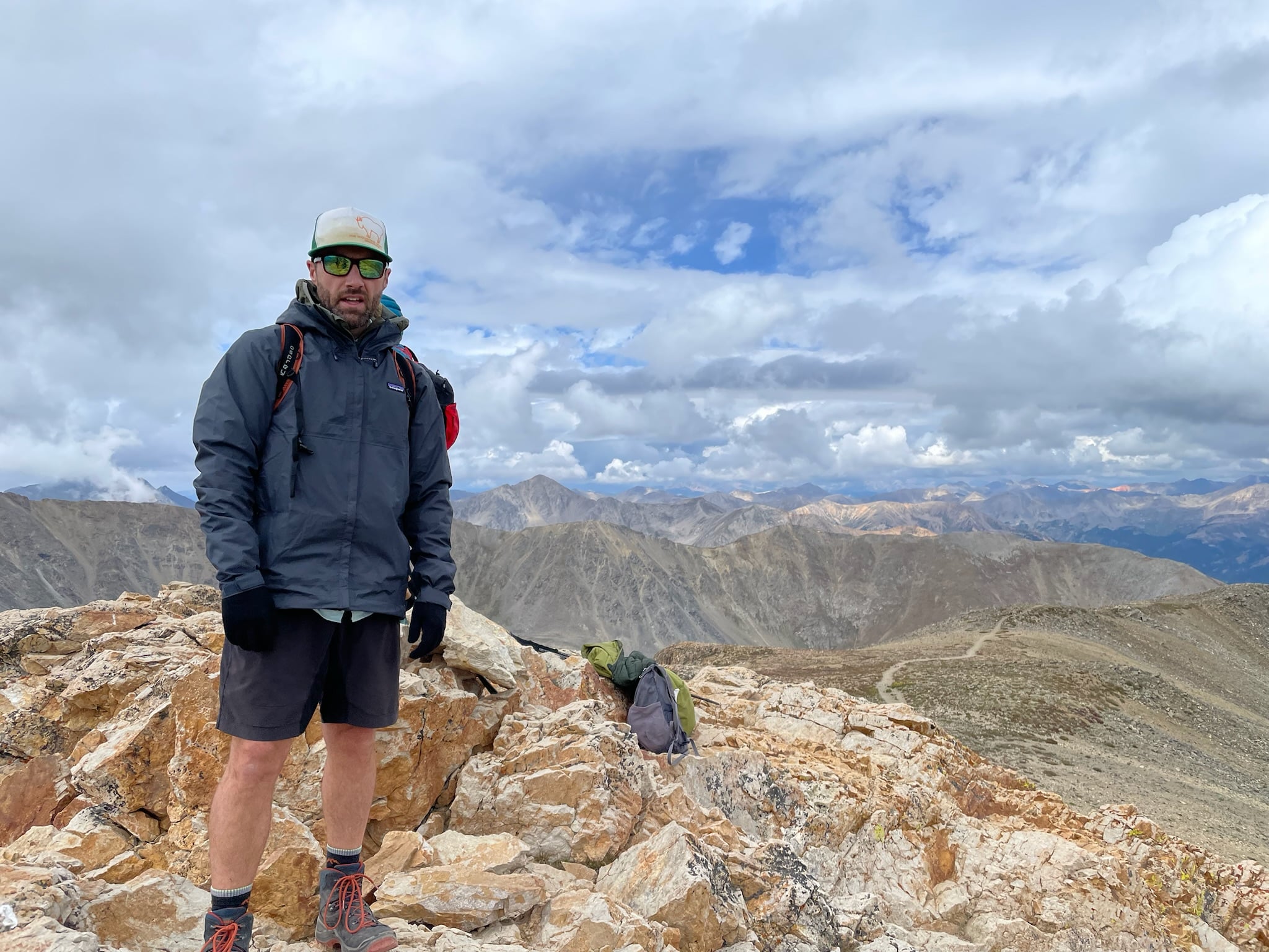 Hiker wearing the Patagonia Torrenshell 3L rain jacket at 14,000' elevation in the Colorado Rocky Mountains.
