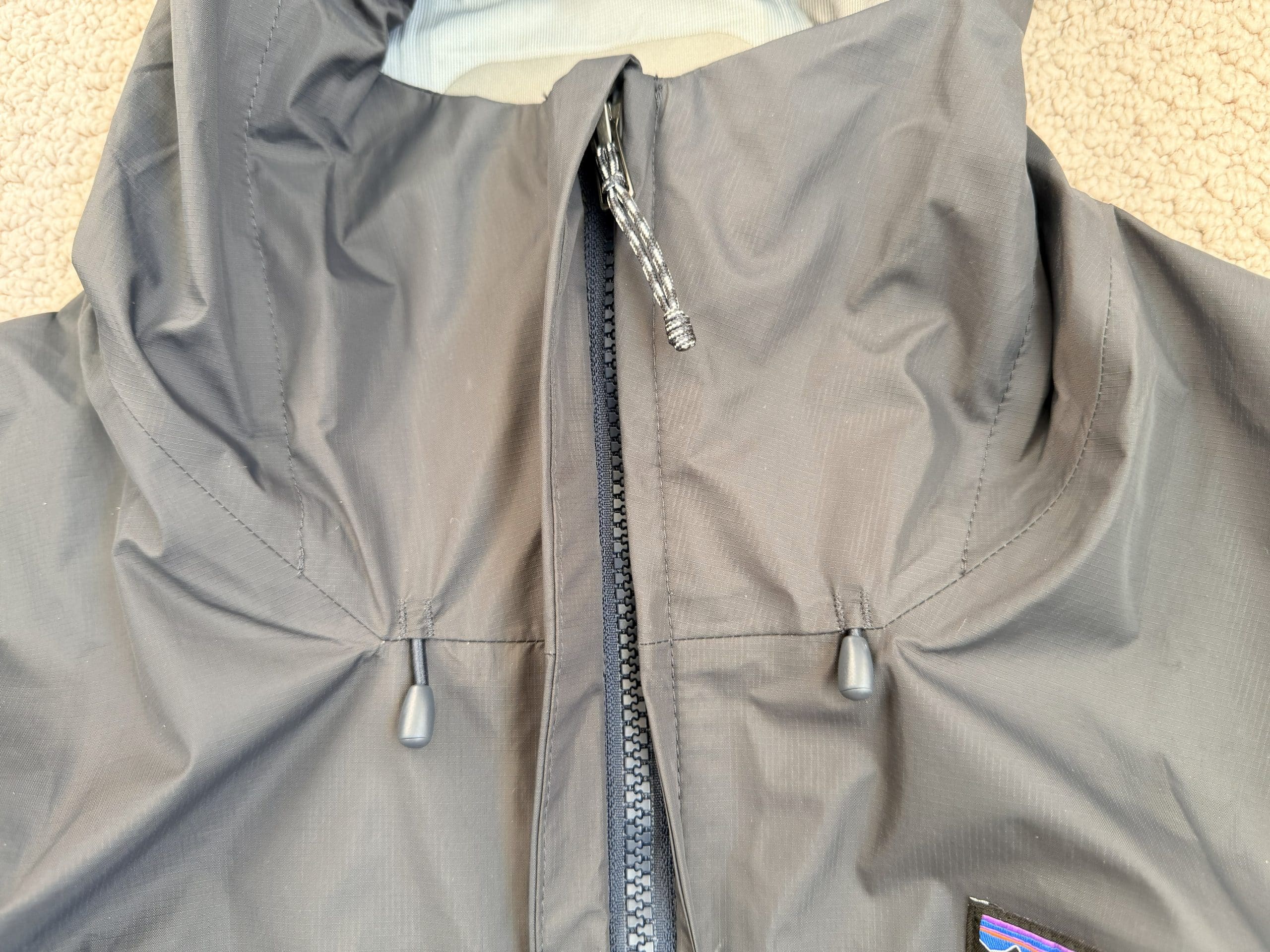 A closeup of the zipper on the Patagonia Torrentshell 3L rain jacket.