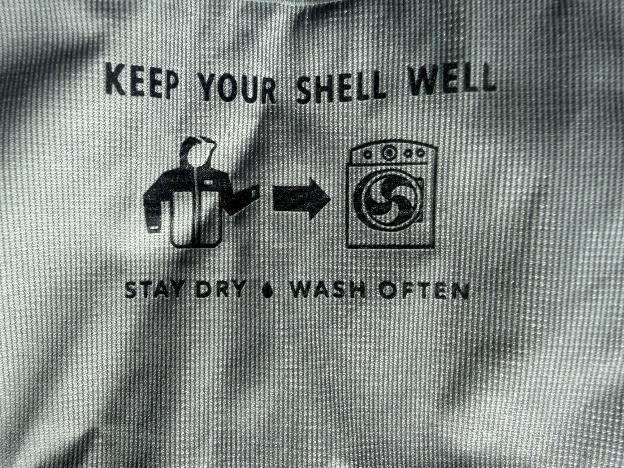 Patagonia's message to wash your jacket, printed on the inside of their shells.